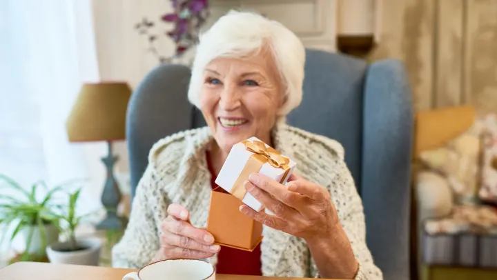 elderly woman holding gift
