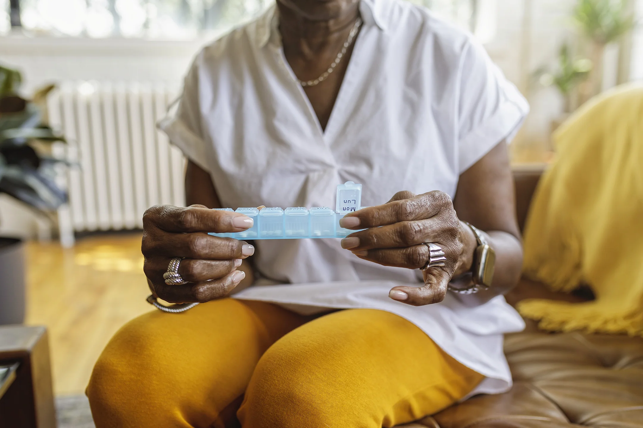 senior woman holding pill packet